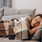 Beautiful,Serene,Woman,Sleeping,On,Comfy,Sofa,Under,Warm,Cozy