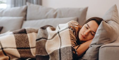 Beautiful,Serene,Woman,Sleeping,On,Comfy,Sofa,Under,Warm,Cozy