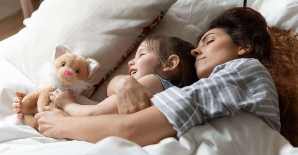 Mom,Hug,Small,Daughter,During,Daytime,Nap,In,Bed,,Close